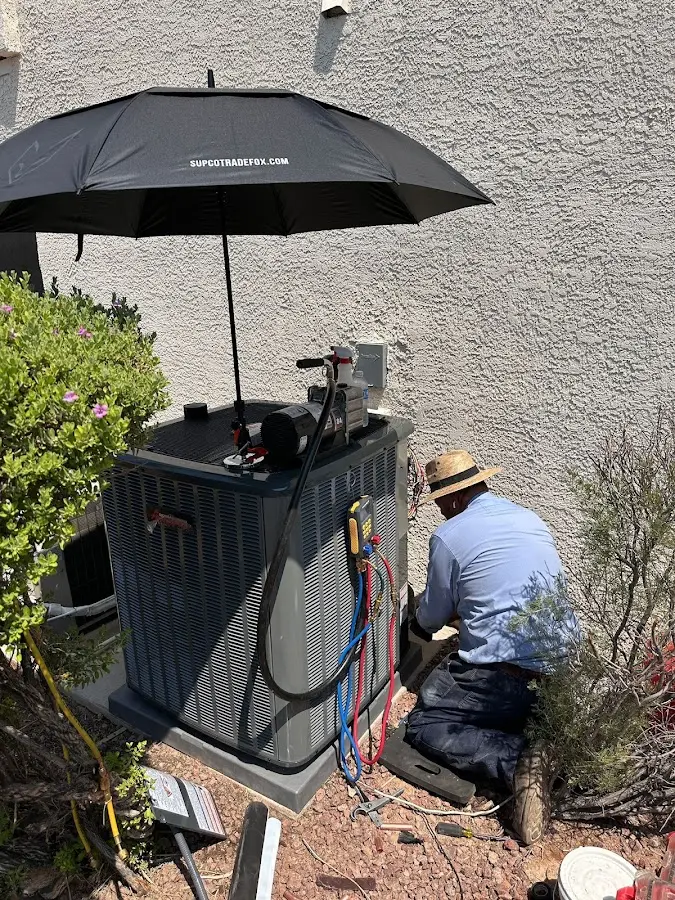 HVAC technician performing outdoor AC maintenance in La Feria